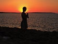 woman in prayer gesture at sunset Royalty Free Stock Photo