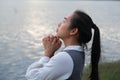 Woman praying alone at sunset. Woman pray for god blessing to wishing have a better life. Spiritual and religion concept Royalty Free Stock Photo