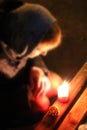 Woman praying with candle. Prayer in church with burning candle. Easter eve