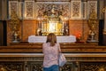 Woman praying in a chapel inside the cathedral basilica del Pilar in Zaragoza, Spain. Royalty Free Stock Photo