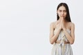 Woman praying before dinner, thanking for food. Portrait of relaxed and calm good-looking hopeful female, closing eyes