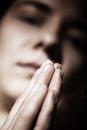 Woman praying with folded hands Royalty Free Stock Photo