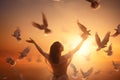 Woman praying and free bird enjoying nature on sunset background, hope concept Royalty Free Stock Photo