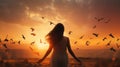 Woman praying and free the birds flying on sunset background, hope concept Royalty Free Stock Photo