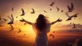 Woman praying and free the birds flying on sunset background, hope concept Royalty Free Stock Photo