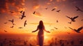 Woman praying and free the birds flying on sunset background, hope concept Royalty Free Stock Photo