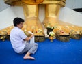 A woman praying at Giant Buddha in Bangkok, Thailand