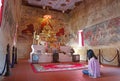Woman Praying in Gorgeous Old Ordination Hall of Wat Chomphuwek Buddhist Temple, a National Ancient Monument in Thailand