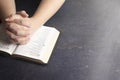 Woman Praying with Her Hands Clasped on a Bible Royalty Free Stock Photo