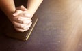 Woman Praying with Her Hands Clasped on a Bible Royalty Free Stock Photo
