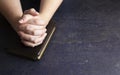 Woman Praying with Her Hands Clasped on a Bible Royalty Free Stock Photo