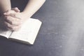 Woman Praying with Her Hands Clasped on a Bible Royalty Free Stock Photo