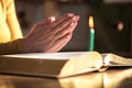 Woman praying with her hands over the bible, hard light Royalty Free Stock Photo