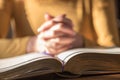 Woman praying with her hands over the bible, hard light Royalty Free Stock Photo
