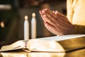 Woman praying with her hands over the bible, hard light Royalty Free Stock Photo