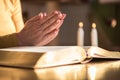 Woman praying with her hands over the bible, hard light Royalty Free Stock Photo