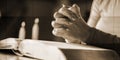 Woman praying with her hands over the bible, hard light, geometric pattern Royalty Free Stock Photo