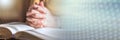 Woman praying with her hands over the bible, hard light; panoramic banner Royalty Free Stock Photo