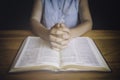 Woman praying with her hands over the bible. Royalty Free Stock Photo