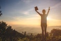 Woman praying while holding Bible and cross, Pray in the Morning , Woman praying with hands together on the Sunrise background Royalty Free Stock Photo