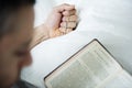 A woman praying while holding cross Royalty Free Stock Photo