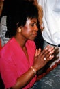 Woman praying intensely during a church service