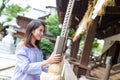 Woman praying in japanese temple with ringing the bell Royalty Free Stock Photo