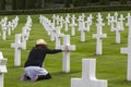 Woman praying in a memorial cemetery Royalty Free Stock Photo