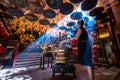 Woman praying in misty temple