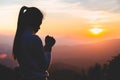 Woman praying in the morning on the sunrise background. Christianity concept. Pray background. Faith hope love concept