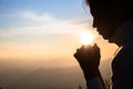 Woman praying in the morning on the sunrise background. Christianity concept. Pray background. Faith hope love concept Royalty Free Stock Photo