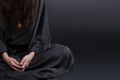 Woman praying. Prayer dressed in Vestments of a nun on gray studio background. Religion and hope concept Royalty Free Stock Photo