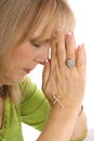 Woman praying with rhinestone cross upclose