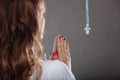 Woman praying to god jesus with cross necklace. Royalty Free Stock Photo