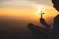 A women is praying to God on the mountain. Praying hands with faith in religion and belief in God on blessing background. Power of Royalty Free Stock Photo