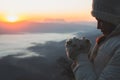 A women is praying to God on the mountain. Praying hands with faith in religion and belief in God on blessing background. Power of Royalty Free Stock Photo