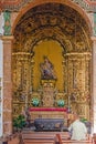 Woman praying to a pieta statue in the Sao Bento monastery.