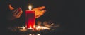 Woman Praying and worship to GOD Using hands to pray in religious beliefs and worship christian with Red Candle with fire against Royalty Free Stock Photo