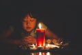 Woman Praying and worship to GOD Using hands to pray in religious beliefs and worship christian with Red Candle with fire against Royalty Free Stock Photo