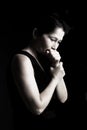 Woman prays on a black background Royalty Free Stock Photo