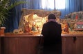 A woman prays in front of the Christmas creches in the Basilica of the Sacred Heart in Zagreb