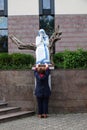 A woman prays in front of the statue of St. Mother Teresa in front of St. Paul`s Cathedral in Tirana, Albania