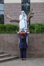 A woman prays in front of the statue of St. Mother Teresa in front of St. Paul`s Cathedral in Tirana, Albania