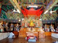 A woman prays inside one of the colorful Buddhist temples in Beomeosa. Busan, Korea