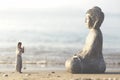 Woman prays meditating in front of the Buddha statue