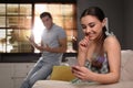 Woman preferring smartphone over spending time with boyfriend at home. Jealousy in relationship