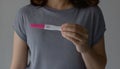woman with a pregnancy test. Close-up of young woman hand holding pregnancy test with two stripes Royalty Free Stock Photo