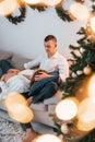 Woman is pregnant. Lovely couple celebrating holidays together indoors Royalty Free Stock Photo