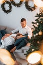 Woman is pregnant. Lovely couple celebrating holidays together indoors Royalty Free Stock Photo