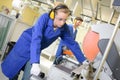 Woman preparaing to cut metal with circular saw